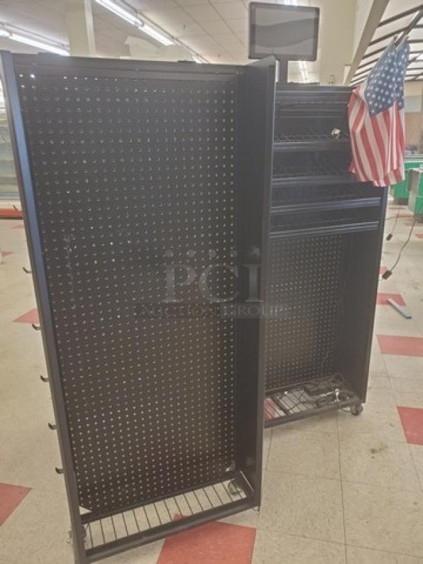 Black checklane shelving unit with pegboard, attached American flag, multiple shelves, and caster wheels for mobility.