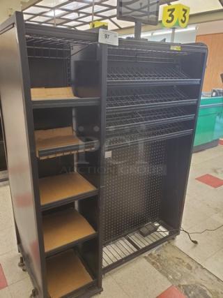 Steel checklane shelving unit with multiple wire shelves and wooden base inserts. Black finish, used condition, item number 97.