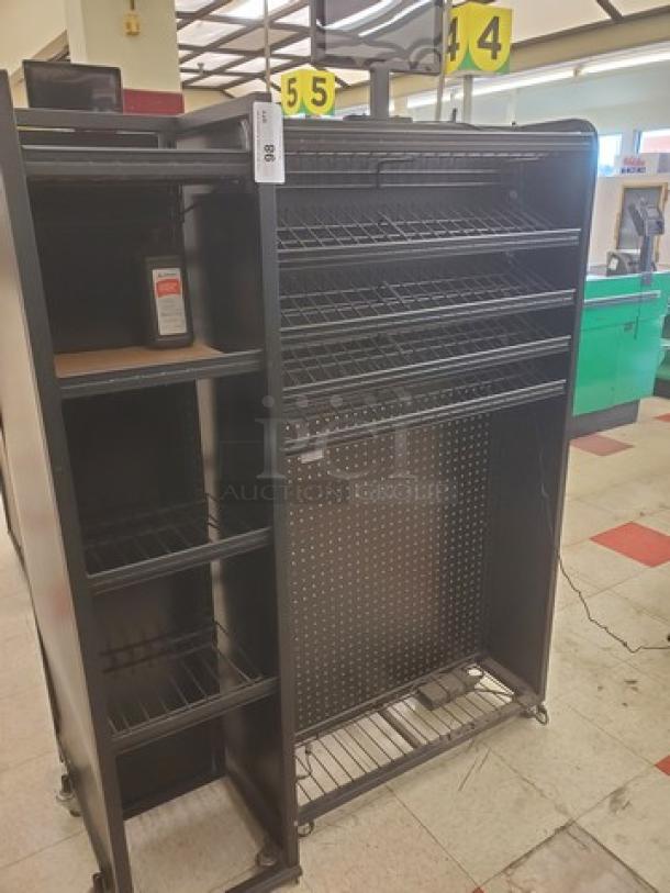 Checklane shelving unit with multiple wire shelves and pegboard back, black finish, used condition, suitable for retail.