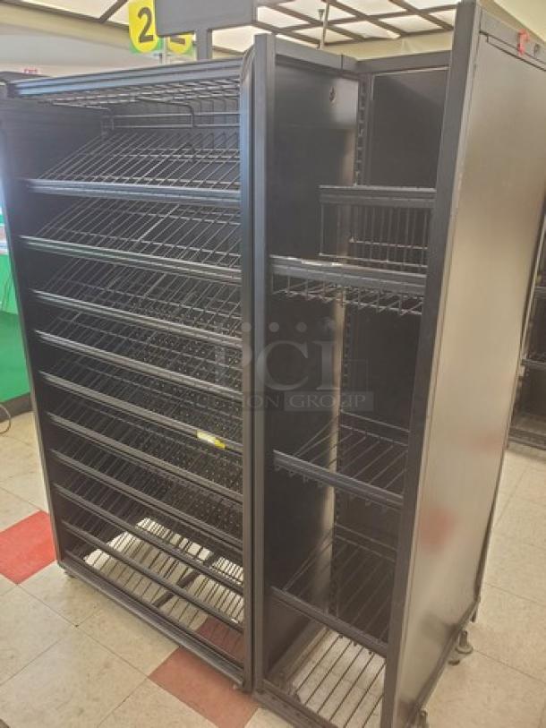 Checklane shelving unit with multiple adjustable wire shelves, metal construction, on casters for mobility, in good condition.