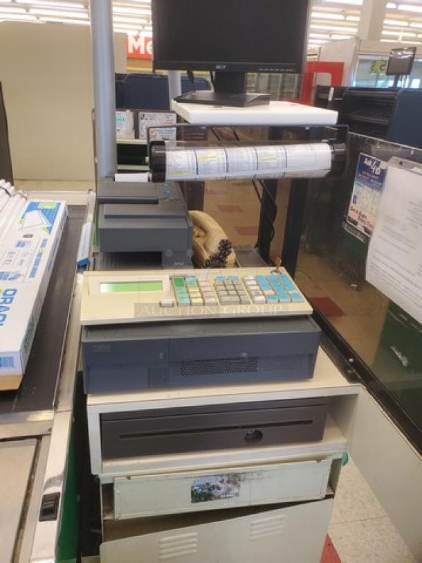 Supermarket checkout counter with cash register, monitor, and receipt printer. Good condition, suitable for retail use.