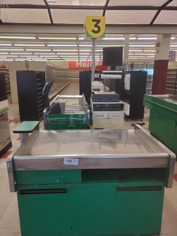 Green Madix supermarket checkout counter, metal finish, with a numbered sign and conveyor belt. Good condition.