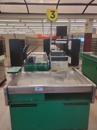 Green Madix supermarket checkout counter, metal finish, with a numbered sign and conveyor belt. Good condition.