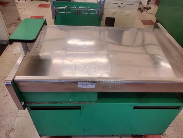 Green Madix supermarket checkout counter with stainless steel top. Minor wear shown. Tag labeled "103". Ideal for retail use.