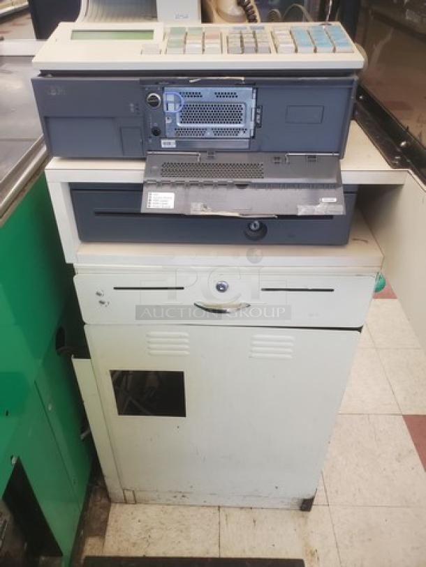 Supermarket checkout counter with integrated POS system, cash drawer, and display. Slight wear indicates used condition.