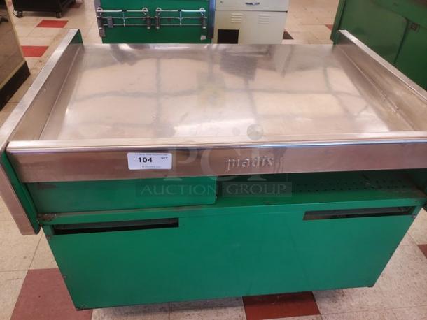 Green supermarket checkout counter by Madix with stainless steel top, item tag reading "104 GVI," in good condition.