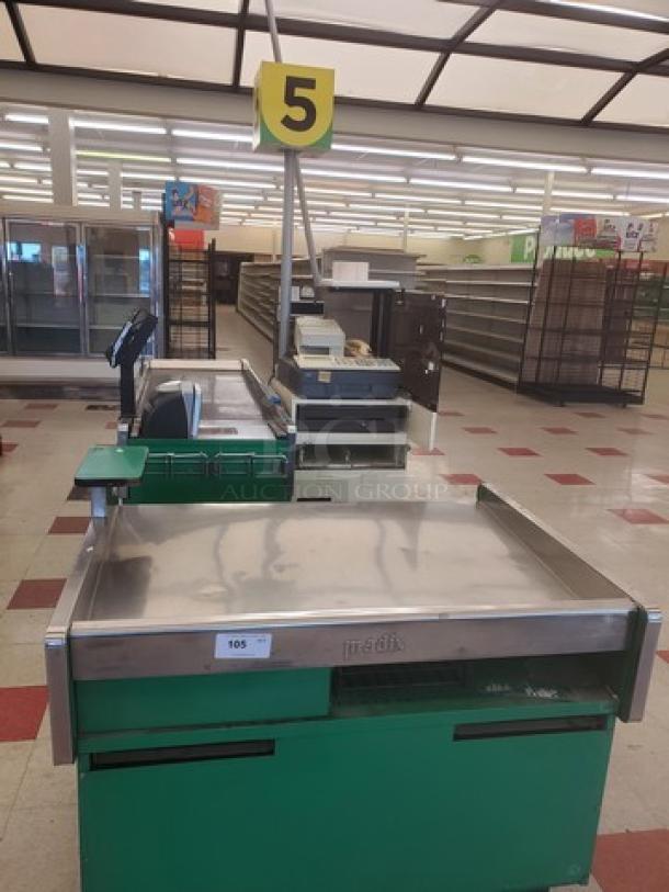 Green supermarket checkout counter with electronic scale, conveyor belt, and cash register. Number 5 sign overhead. Used condition.