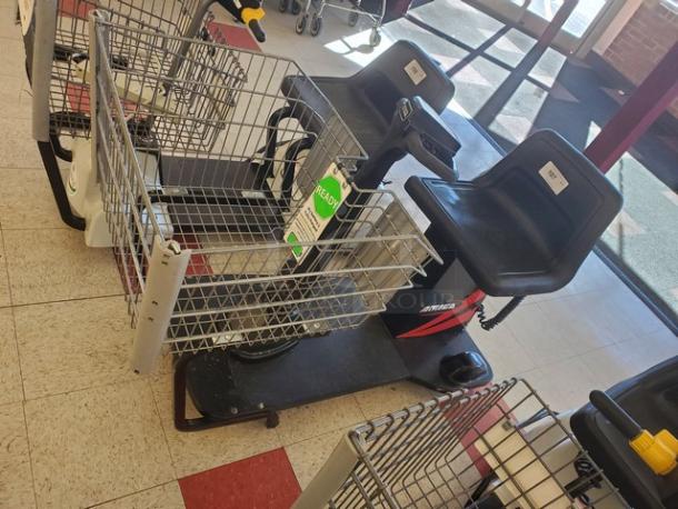 Motorized shopping cart with black seat, metal basket, and "ShopRider" branding. Near mint condition, ready for use.