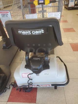 Motorized shopping cart featuring Mart Cart branding, black seat, white base, and steering handlebars. Good condition.