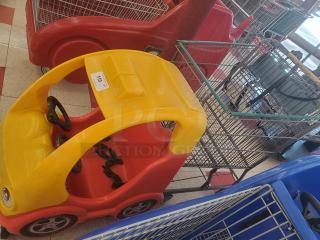 Yellow and red cartoon car shopping cart with steering wheel and child seat harness. Tag visible on top reads "114."
