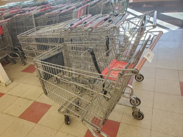 Lot of 5 metal shopping carts in good condition, with red handles and wheels, perfect for retail use.