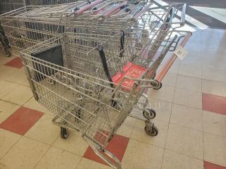 Lot of 5 metal shopping carts with red handles. Used condition, includes labels "5XBID". Wheels appear functional.