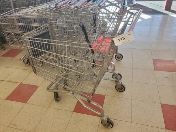 Lot of 5 metal shopping carts in good condition, linked together. Visible tag reads "118 QTY 5." Ideal for retail use.