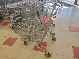 Lot of 5 metal shopping carts in good condition, linked together. Visible tag reads "118 QTY 5." Ideal for retail use.