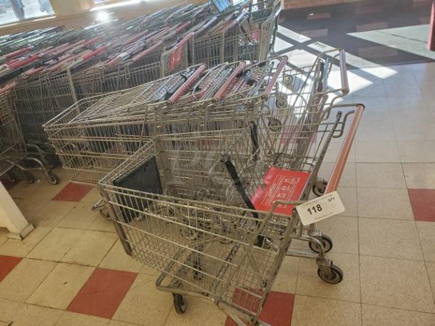 Lot of 5 metal shopping carts in used condition, red handle grips. Number tag "118" visible on one cart.