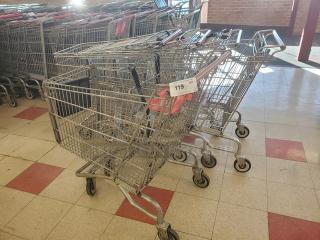 Lot of 5 metal shopping carts, gently used, stacked together. Visible tag numbered 119. Ideal for retail use.