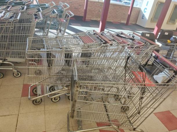Lot of 5 metal shopping carts, used condition, featuring wire baskets and smooth-rolling wheels, ideal for retail stores.