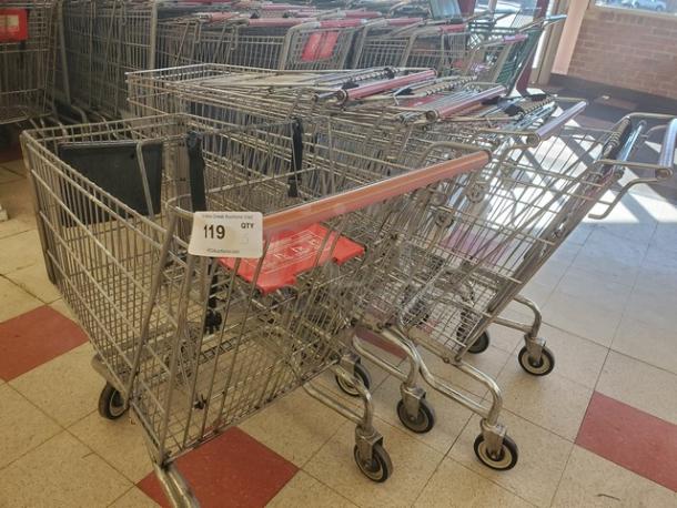 Lot of 5 metal shopping carts with red handles and front accessory baskets, in good condition, auction tag "119."
