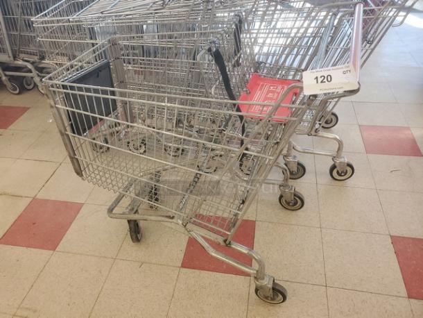 Lot of 5 metal shopping carts in used condition, featuring a wire frame design and swivel wheels. Item tag shows "120 QTY."