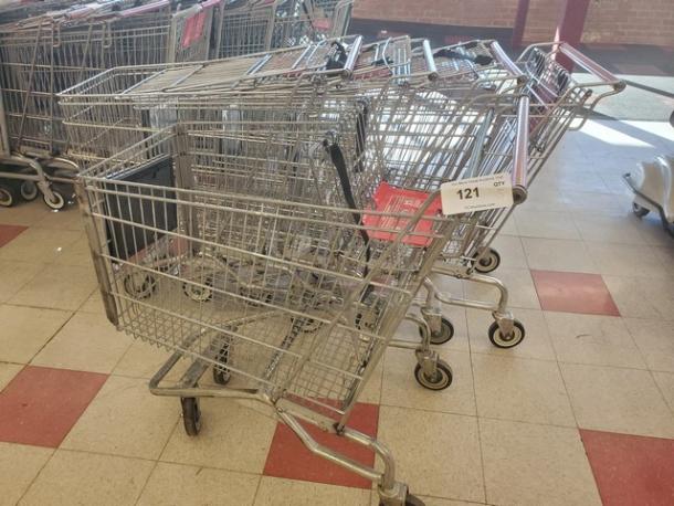 Lot of 5 metal shopping carts with swivel wheels in fair condition, labeled "121." Ideal for retail use.