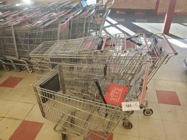 Lot of 5 metal shopping carts with red handles, used condition. Includes item tag labeled "121." Quantity: 5.