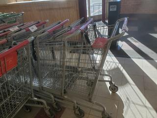 Lot of 5 metal shopping carts with red handles, in used condition. Tags on handles indicate item number and auction details.