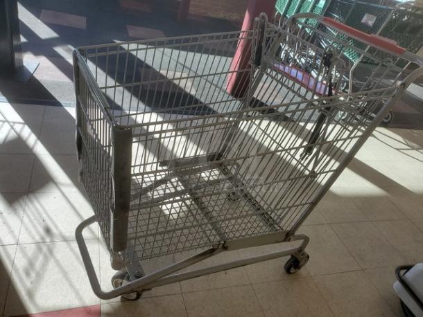 Lot of 5 metal shopping carts in used condition, featuring sturdy wire baskets and functional wheels.