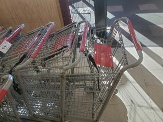 Lot of 3 metal shopping carts with red handles, in good condition, stacked indoors. Tags indicate "3XBID."