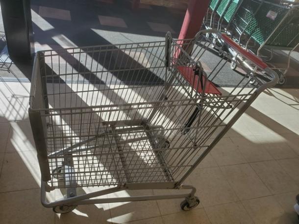 Lot of 3 metal shopping carts, used condition, sturdy wire frames, red handles, suitable for retail use.