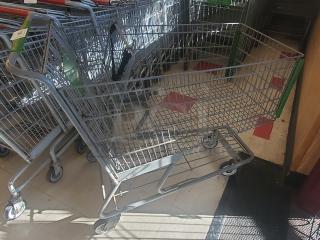 Lot of 4 metal shopping carts in good condition, with swivel wheels and sturdy handles, ideal for retail use.