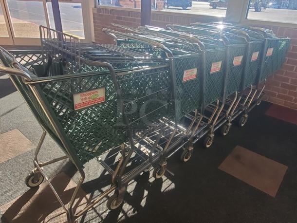 Lot of 8 green metal shopping carts with "Shoppers Value" logo. Good condition, sturdy wheels, ideal for retail use.