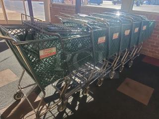 Lot of 8 green metal shopping carts with "Shoppers Value" logo. Good condition, sturdy wheels, ideal for retail use.