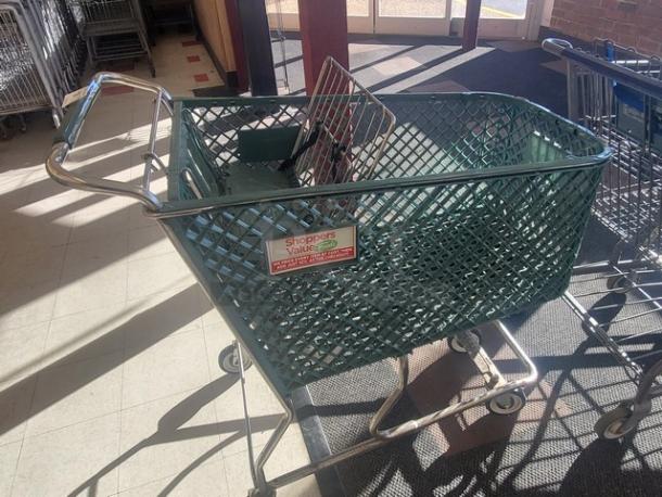 Lot of 4 green shopping carts, metal frame, plastic basket. "Shoppers Value" label visible. Used condition.