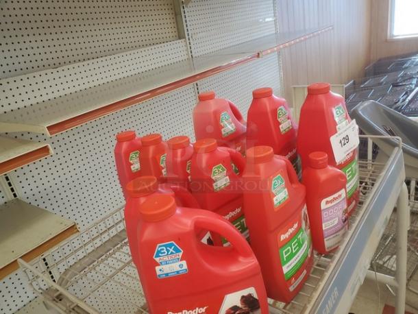 Lot of 16 red jugs of Rug Doctor carpet cleaner, odor remover. Each jug has a green label indicating pet-specific formula and "3X Action" for effective cleaning.