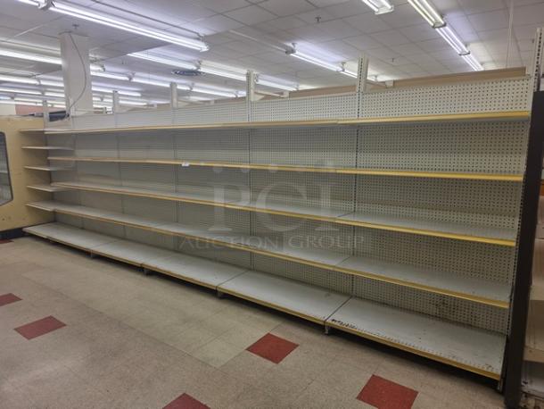Double-sided gondola shelving, 23' long, metal with adjustable shelves, pegboard back, in good condition. Buyer must remove.
