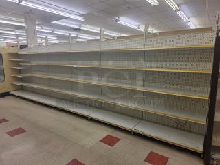 Double-sided gondola shelving, 23' long, metal with adjustable shelves, pegboard back, in good condition. Buyer must remove.