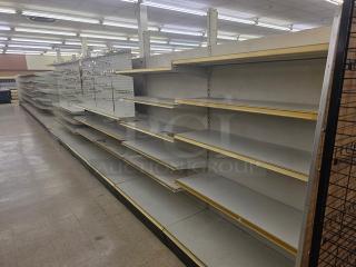 Double-sided gondola shelving, 63', white with beige trim, multiple adjustable shelves, fair condition. Buyer must remove.