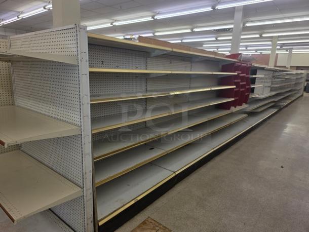 Double-sided gondola shelving, 65', metal and wood, used condition, buyer must remove.