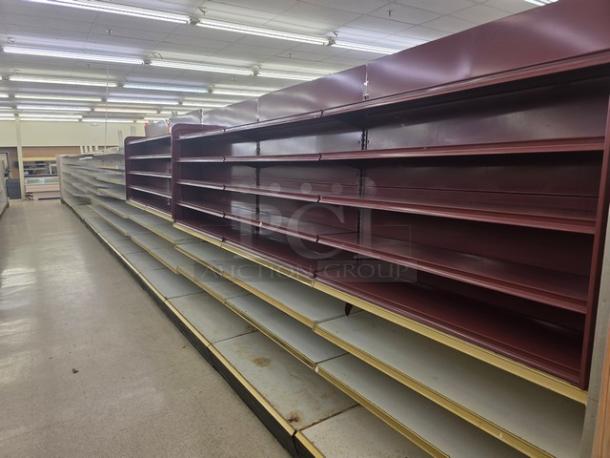 Double sided gondola shelving, 63' long. Burgundy color, multiple adjustable shelves. Buyer must remove. Good condition.