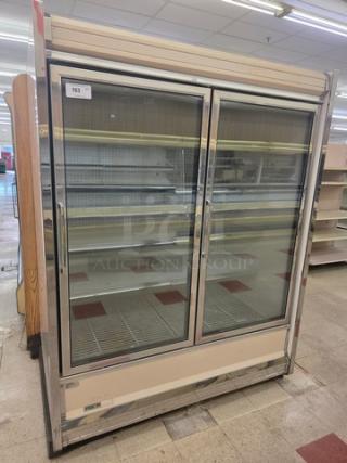 Kysor Warren 2 Door Low Temp Case, model LV5H1-2U, features glass doors, metal shelves, and beige finish; used condition.