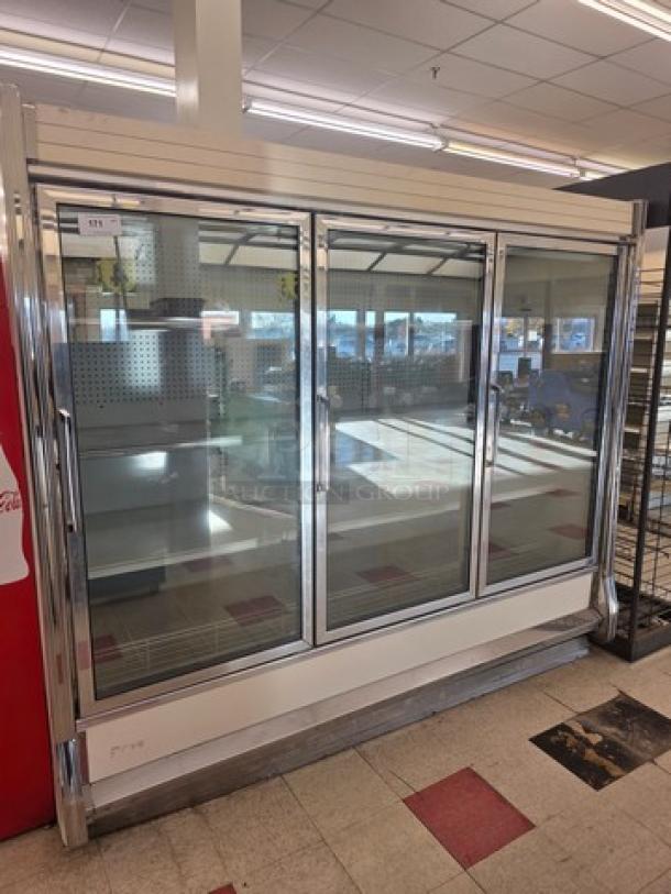 Kysor Warren three glass door freezer in good condition, featuring a stainless steel frame and clear glass doors.