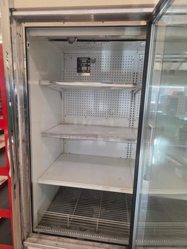 Kysor Warren three glass door freezer, featuring shelves and temperature control panel, in good condition.