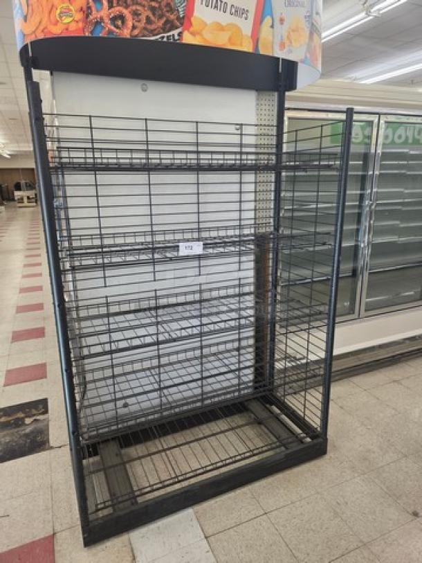 Black wire shelving unit with five adjustable shelves, minimal wear. Includes snack branding on top signage.