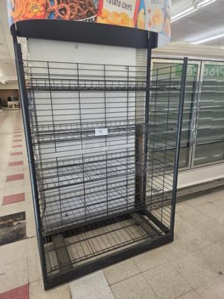 Black wire shelving unit with five adjustable shelves, minimal wear. Includes snack branding on top signage.