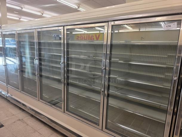 Kysor/Warren freezer display case model LV5H1-5U, no compressor, glass doors, pegboard shelving, sold by the door.