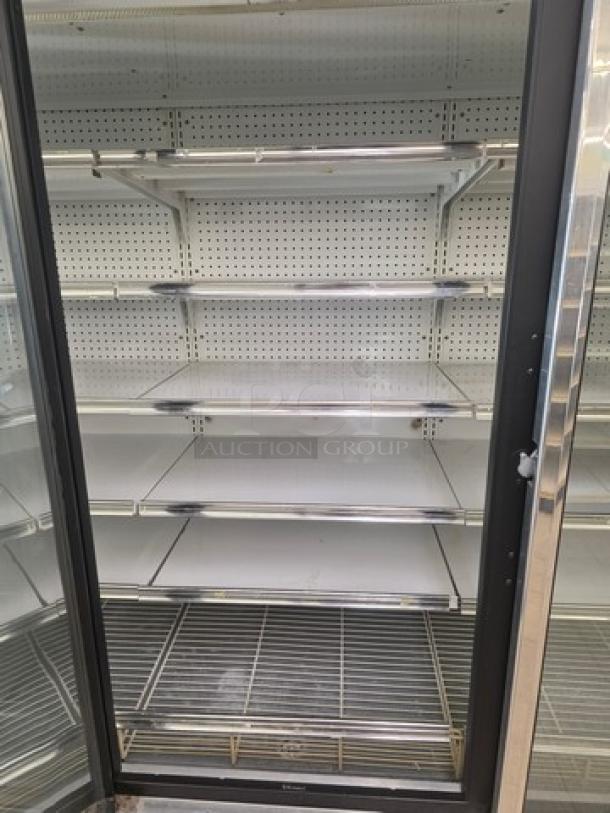 Kysor/Warren freezer display case model LV5H1-5U, no compressor, open door view showing shelves, for sale by the door.