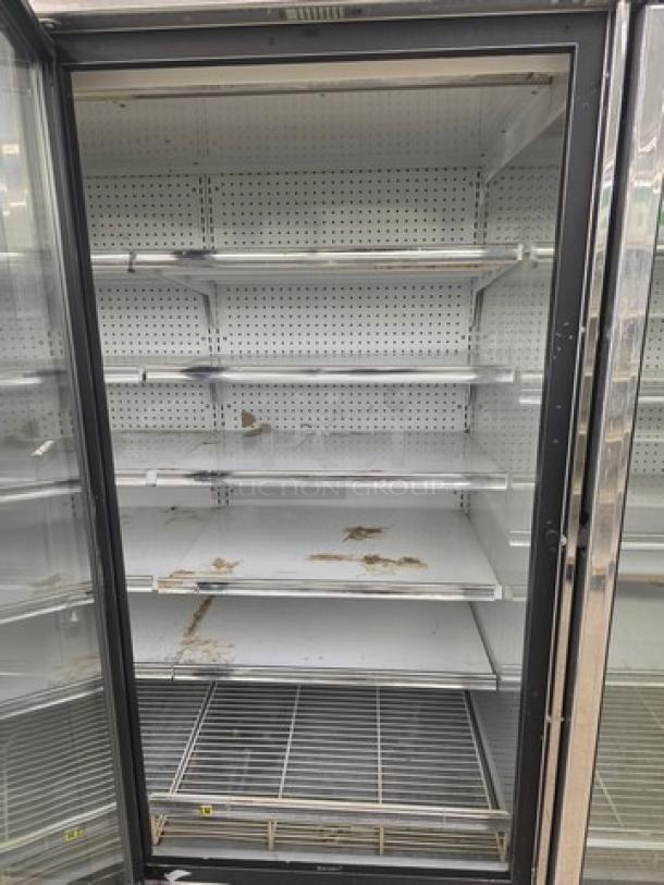 Kysor/Warren freezer display case model LV5H1-5U, no compressor, multiple shelves, visible wear, sold by the door.