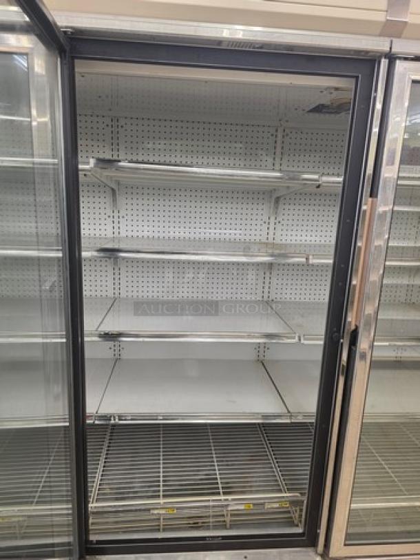 Kysor/Warren freezer display case model LV5H1-5U, no compressor. Shelving included, moderate condition. Sold by the door.