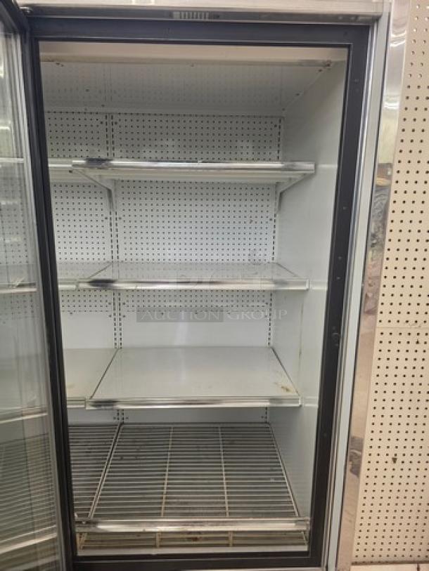 Kysor/Warren freezer display case, model LV5H1-5U, without compressor. Features glass door, metal shelving; sold by the door.