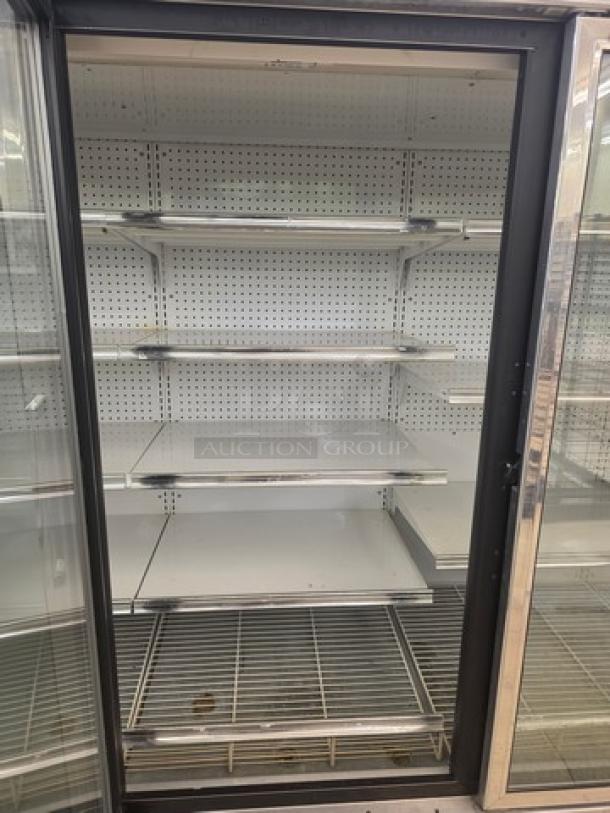 Kysor/Warren freezer display case, model LV5H1-5U, no compressor, sold by the door. Multiple shelves visible.